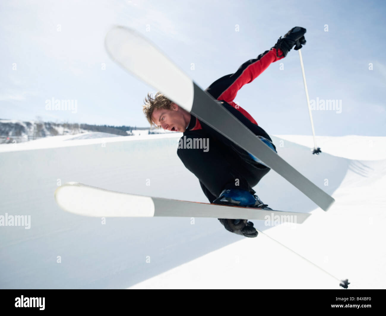 Skier jumping off lip of halfpipe Stock Photo Alamy