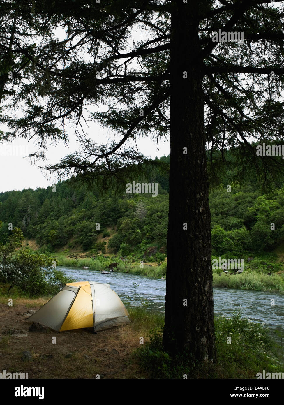 Tent and campsite by river Stock Photo - Alamy