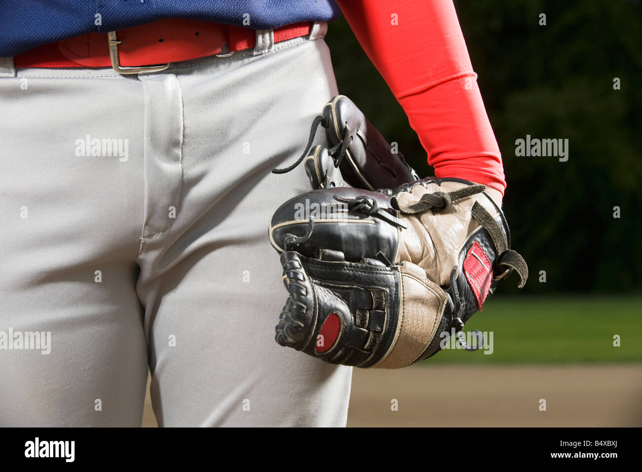 Baseball player holding mitt at side Stock Photo Alamy
