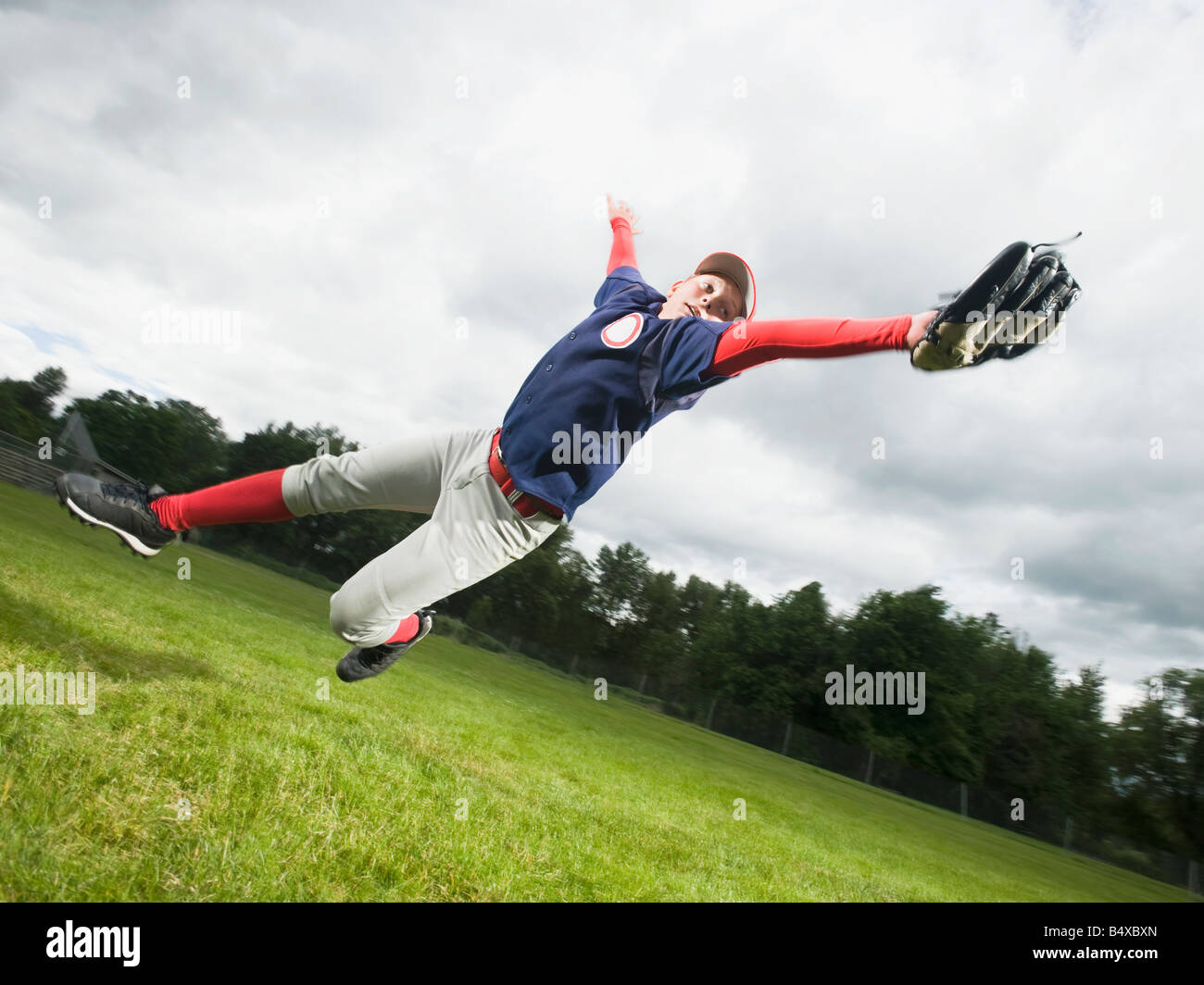 Boy jumping catch baseball hires stock photography and images Alamy