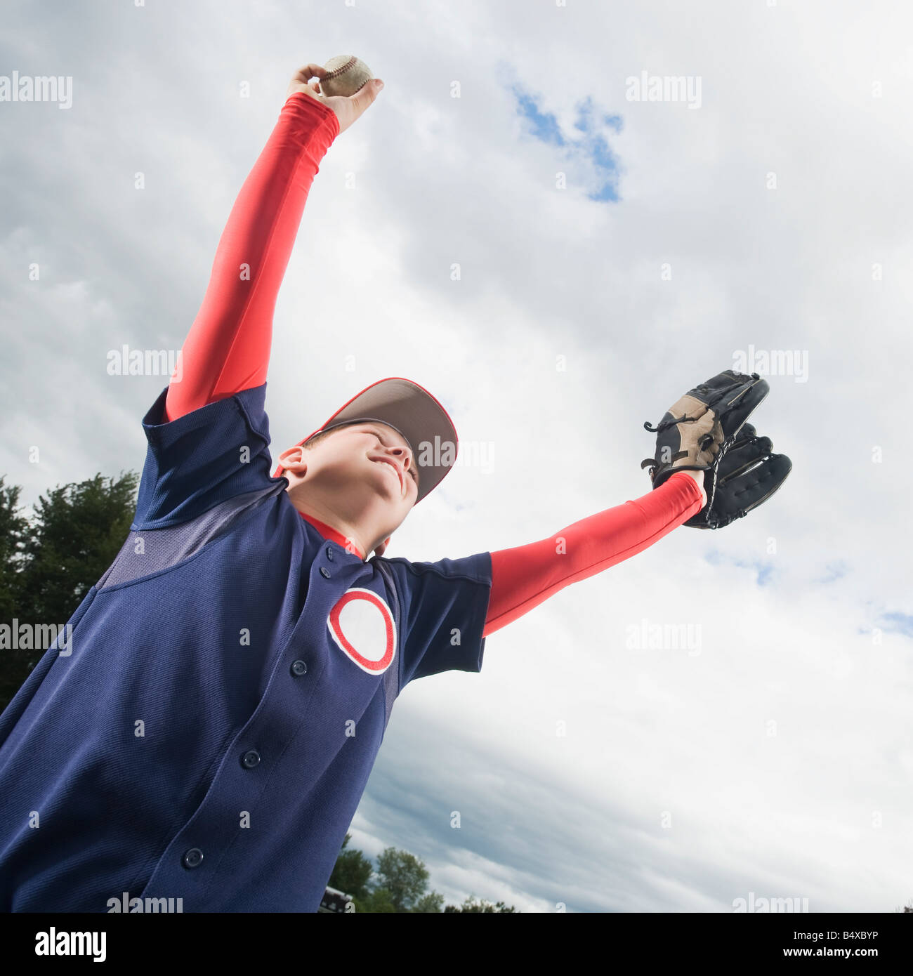 Baseball player celebrating with arms raised Stock Photo Alamy