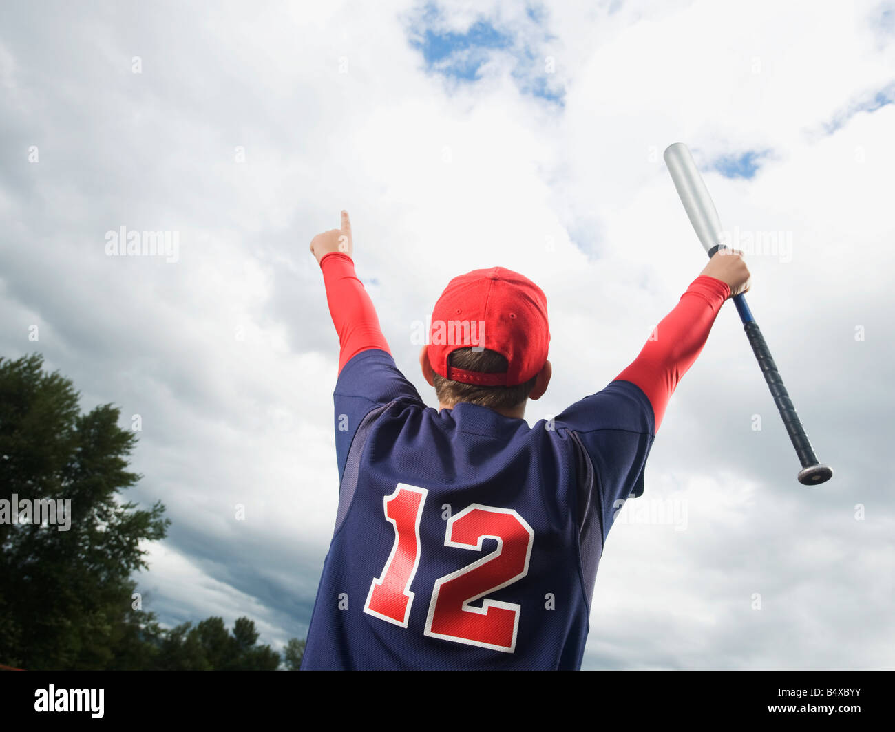 Baseball player celebrating with arms raised Stock Photo Alamy