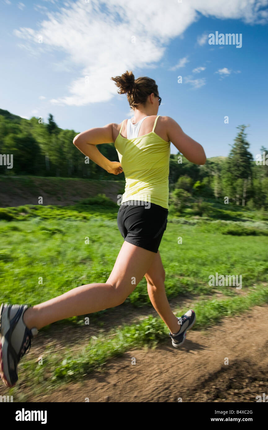Young woman running on trail Stock Photo - Alamy
