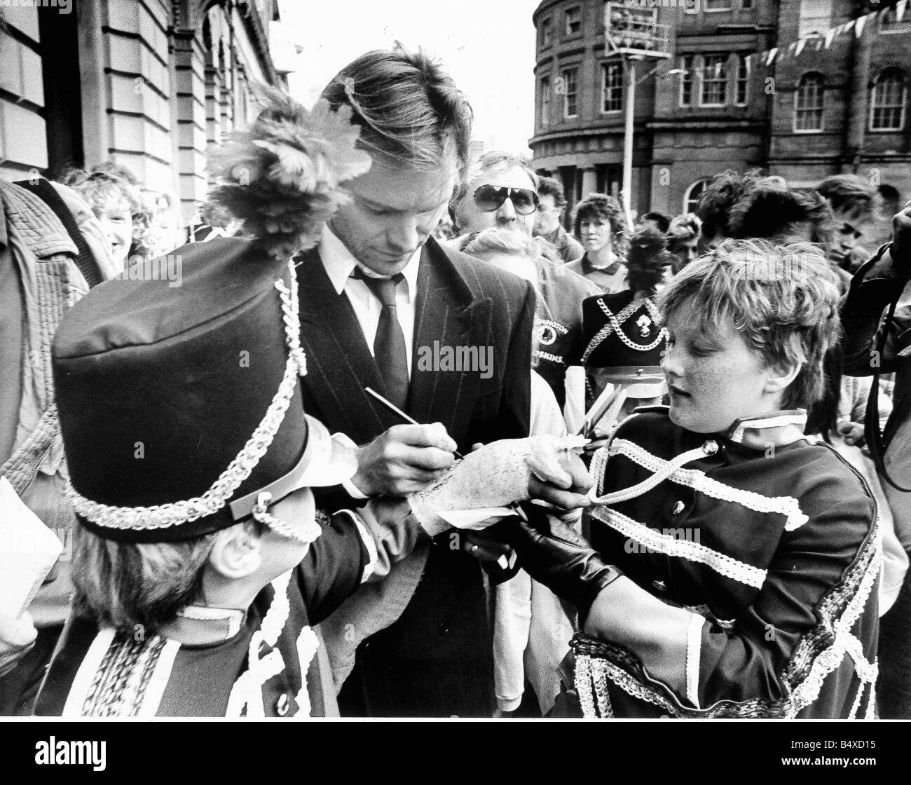 Rock star turned film star Sting who was born in Wallsend was beseiged by autograph hunters when he returned to the North East to shoot scenes for his film Stormy Monday in and around Newcastle s Quayside Stock Photo