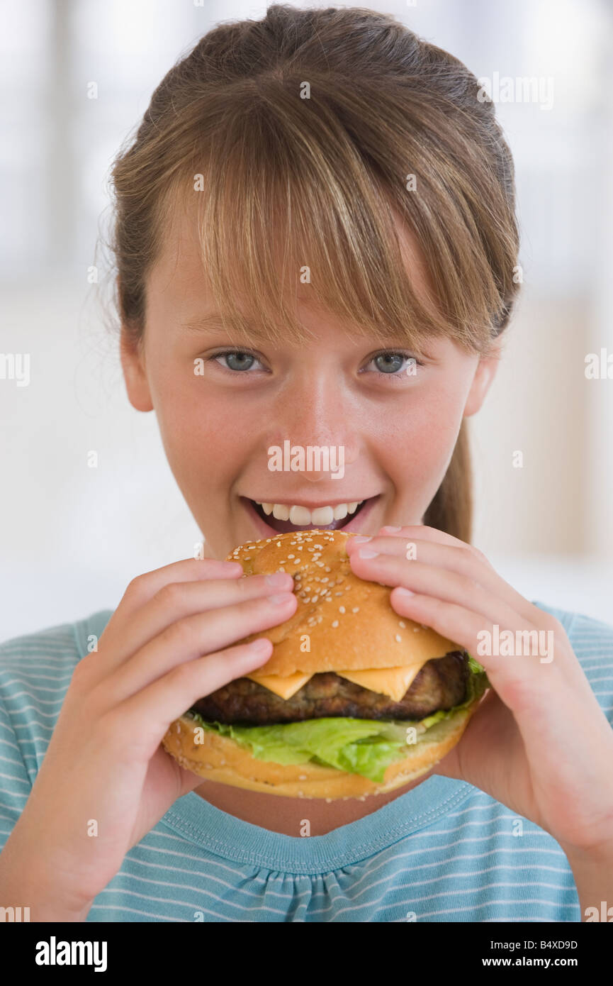 Girl eating hamburger Stock Photo