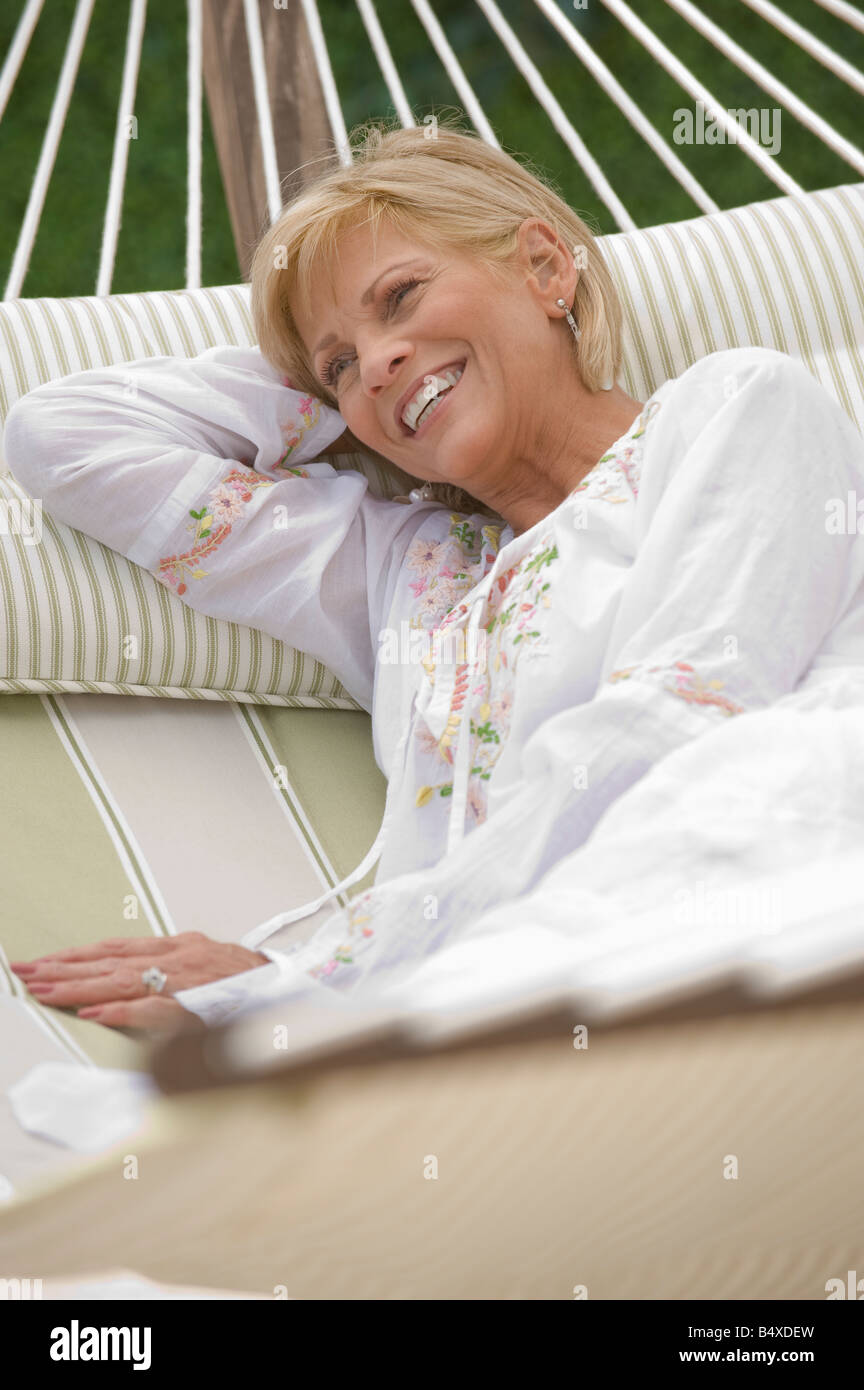Woman relaxing in hammock Stock Photo - Alamy