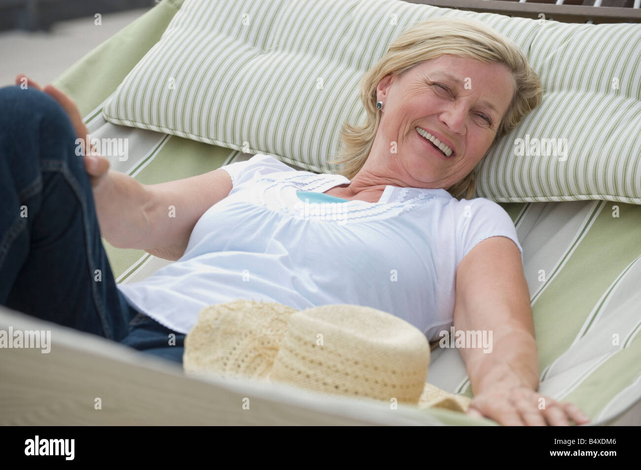 Woman relaxing in hammock Stock Photo - Alamy