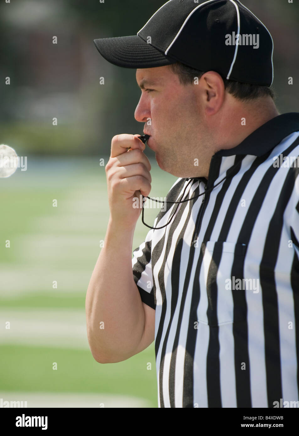 Football referee blowing whistle Stock Photo Alamy