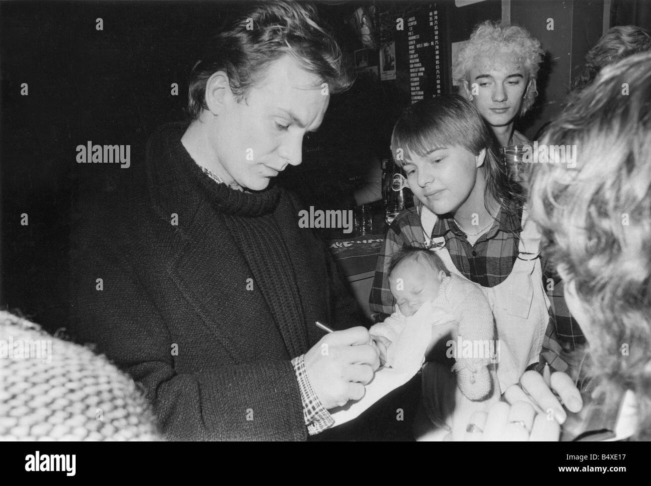 Sting signs his autograph for Jackie Kerr holding her eight week old baby Paula at the Buddle Arts Centre Wallsend Sting presented a cheque for 10 000 to centre manager Tim Archer to enable the purchase of a purpose built sound system Stock Photo