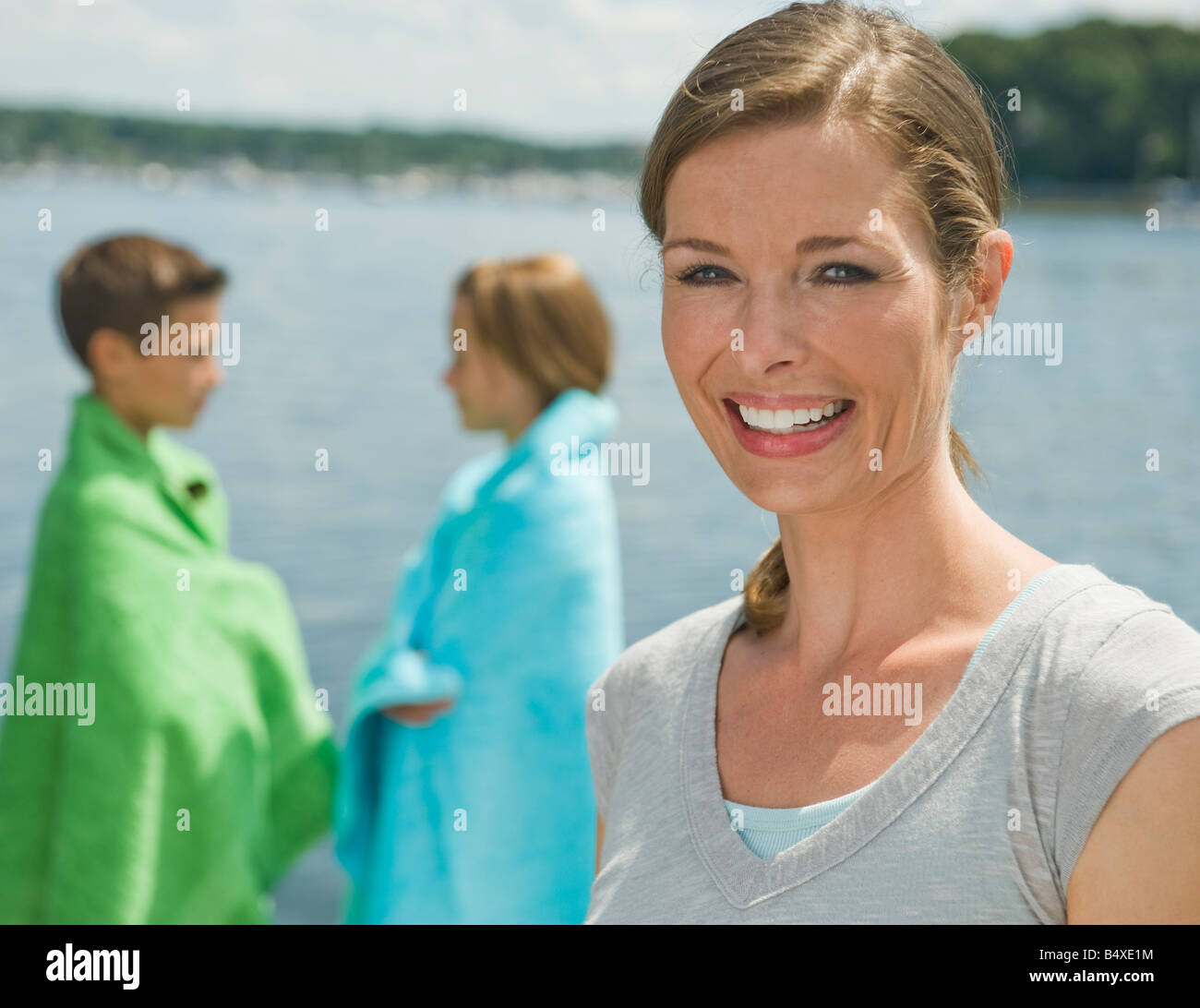 Mother and children on dock Stock Photo