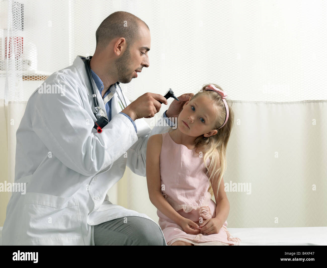 Doctor examining girl Stock Photo
