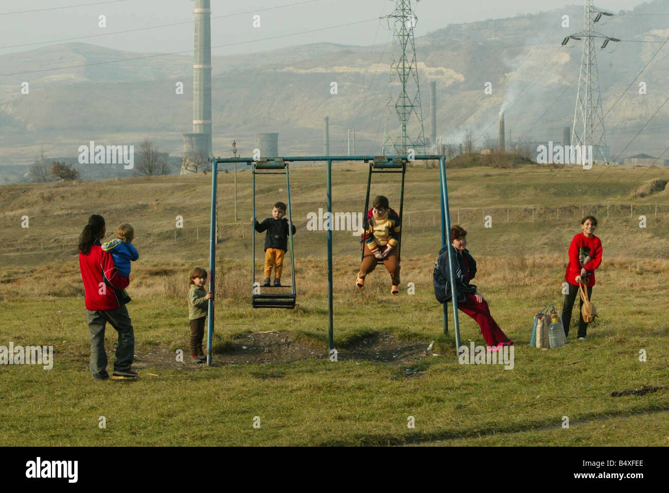 Copsa Mica Romania November 2006 Copsa Mica Europe s most polluted place children play on the swings above the smelting factory Stock Photo