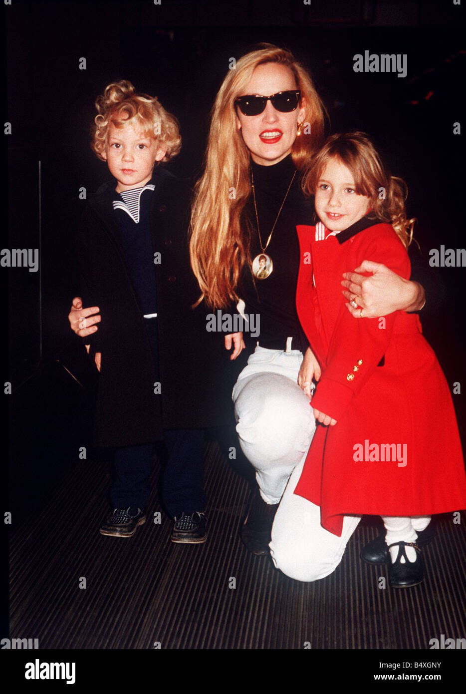 Jerry Hall model with children Elizabeth Scarlet and James at Heathrow airport leaving for a holiday with Mick Jagger Stock Photo
