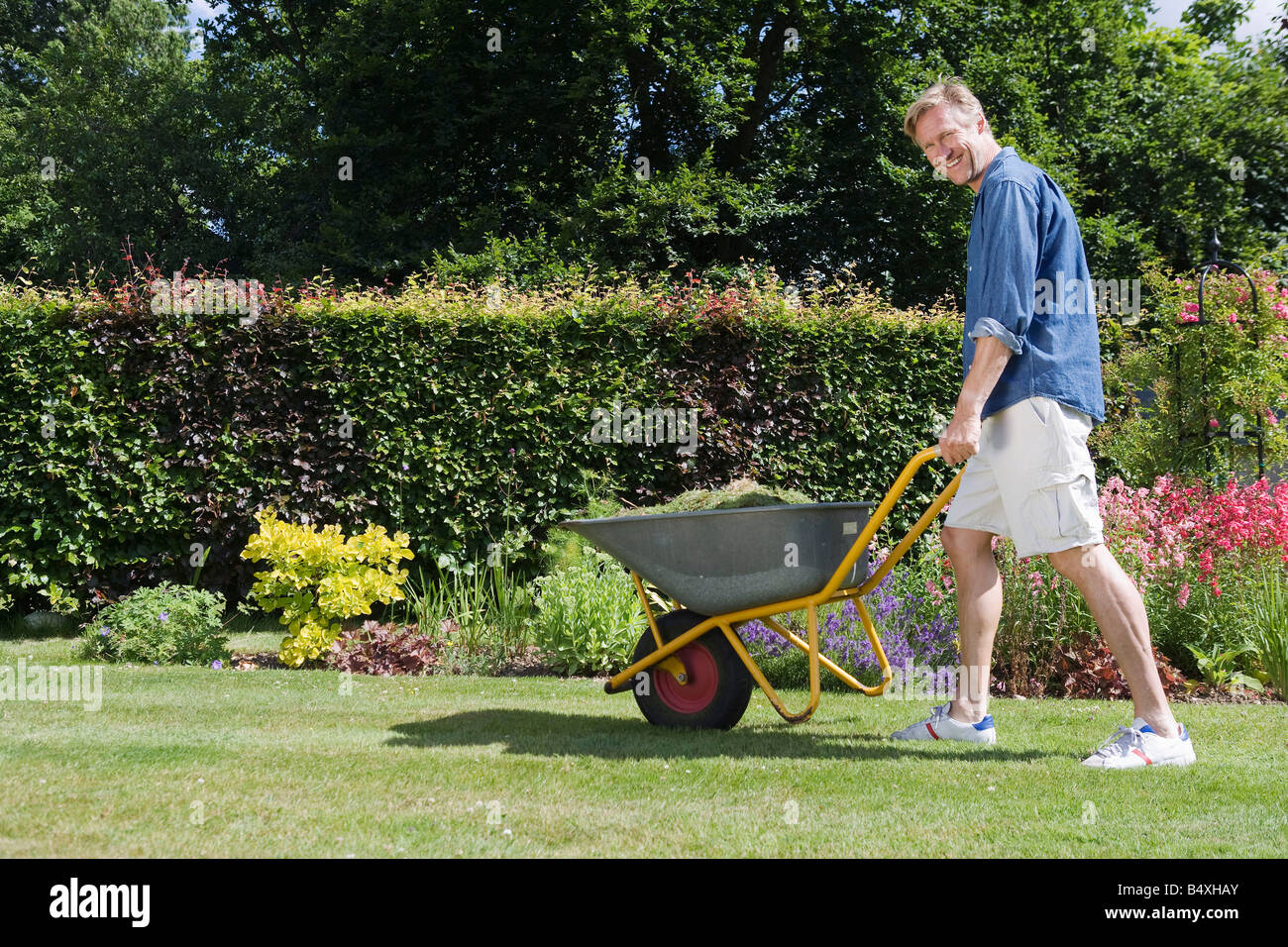 Man walking with wheelbarrow Stock Photo 20253379 Alamy