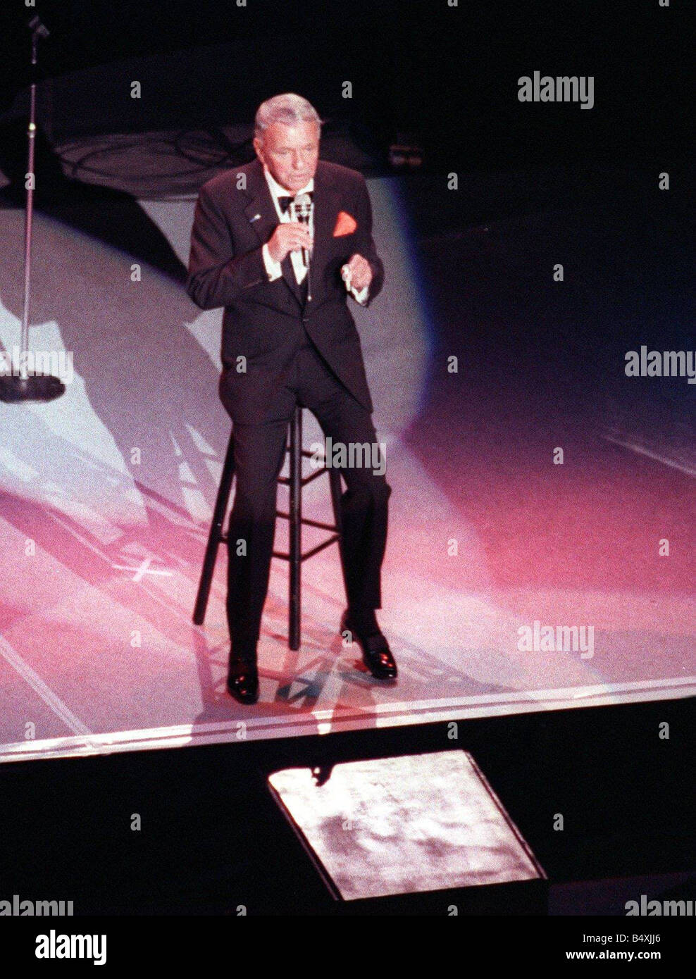 Frank Sinatra in concert sitting on high stool Ibrox July 1990 Glasgow Stock Photo