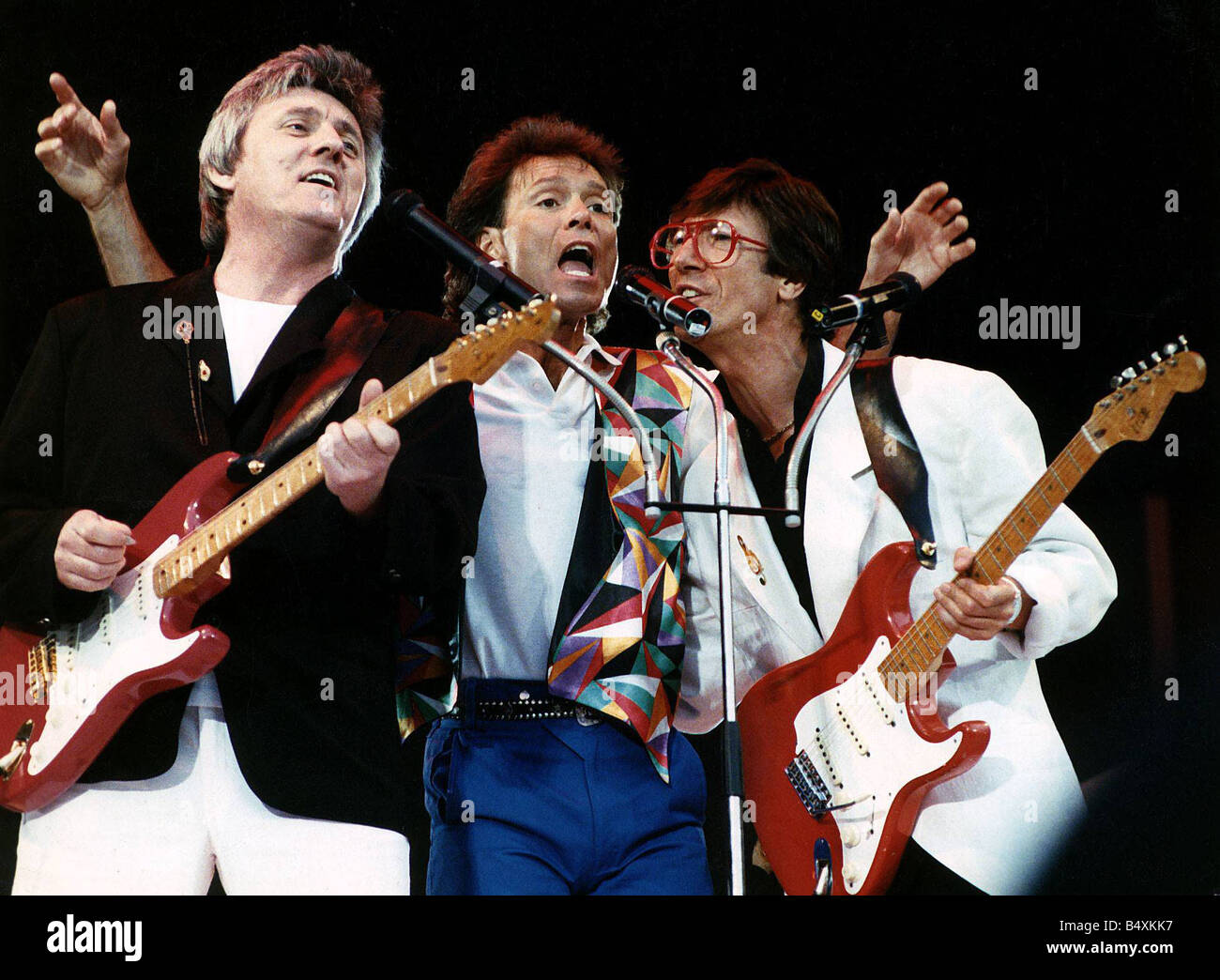Cliff Richard Singer reunites with Bruce Welch and Hank Marvin members of his old backing group The Shadows on stage at Webley Stadium for his anniversary concert Music Stock Photo