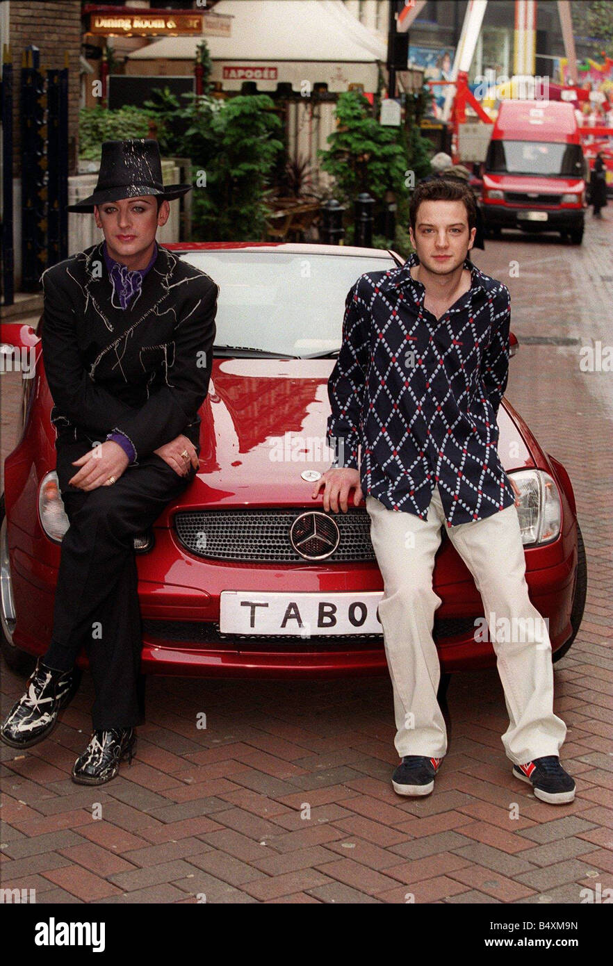 Boy George and Euan Morton December 2001 TABOO number place red Mercedes car Culture Club star new musical called Taboo Stock Photo
