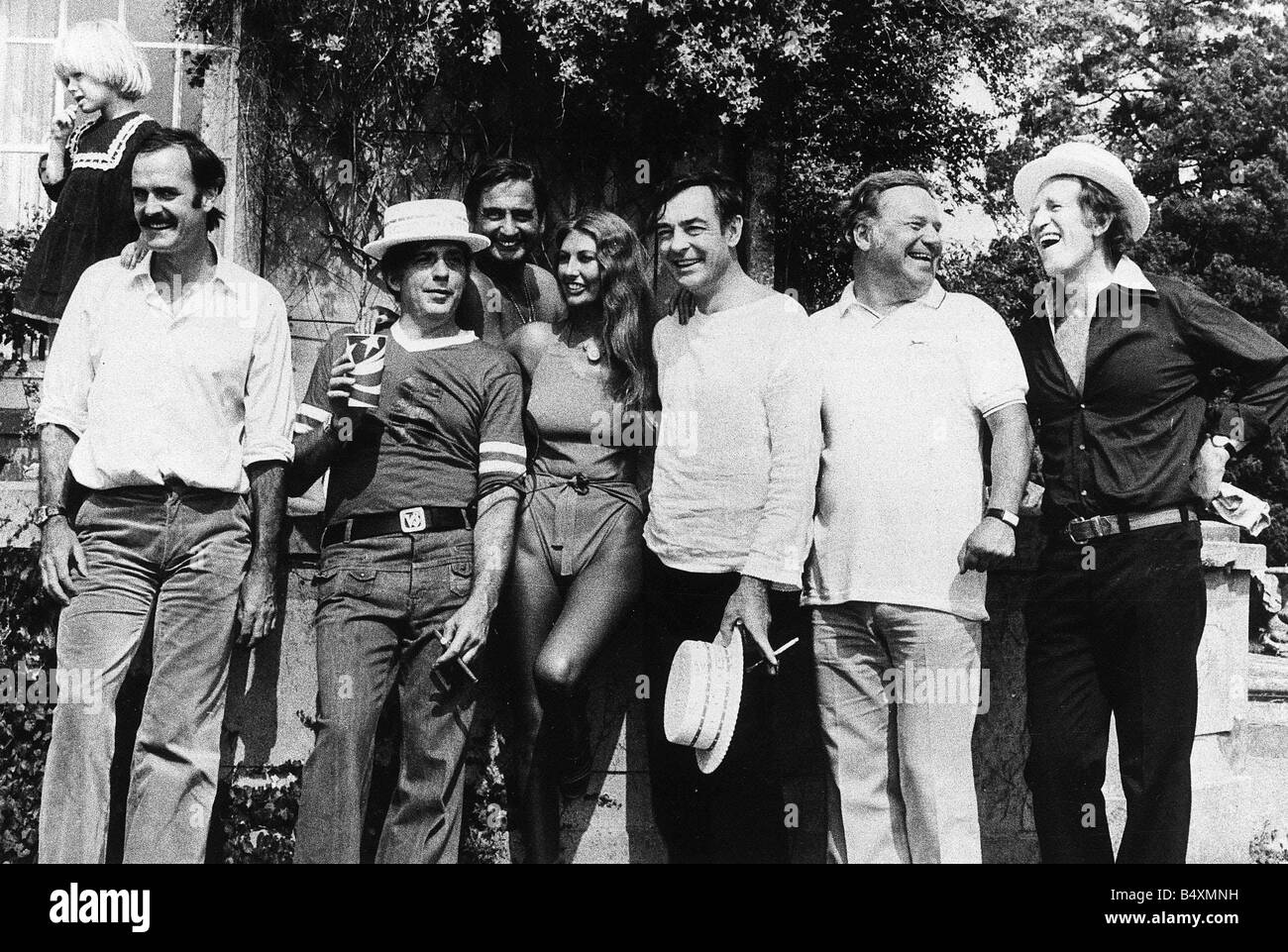 Marilyn Cole former Playmate of the Year with left to right John Cleese Victor Lownes Bernie Winters Richard Johnston Reginald Bosanquet and Lance Percival 1976 Stock Photo