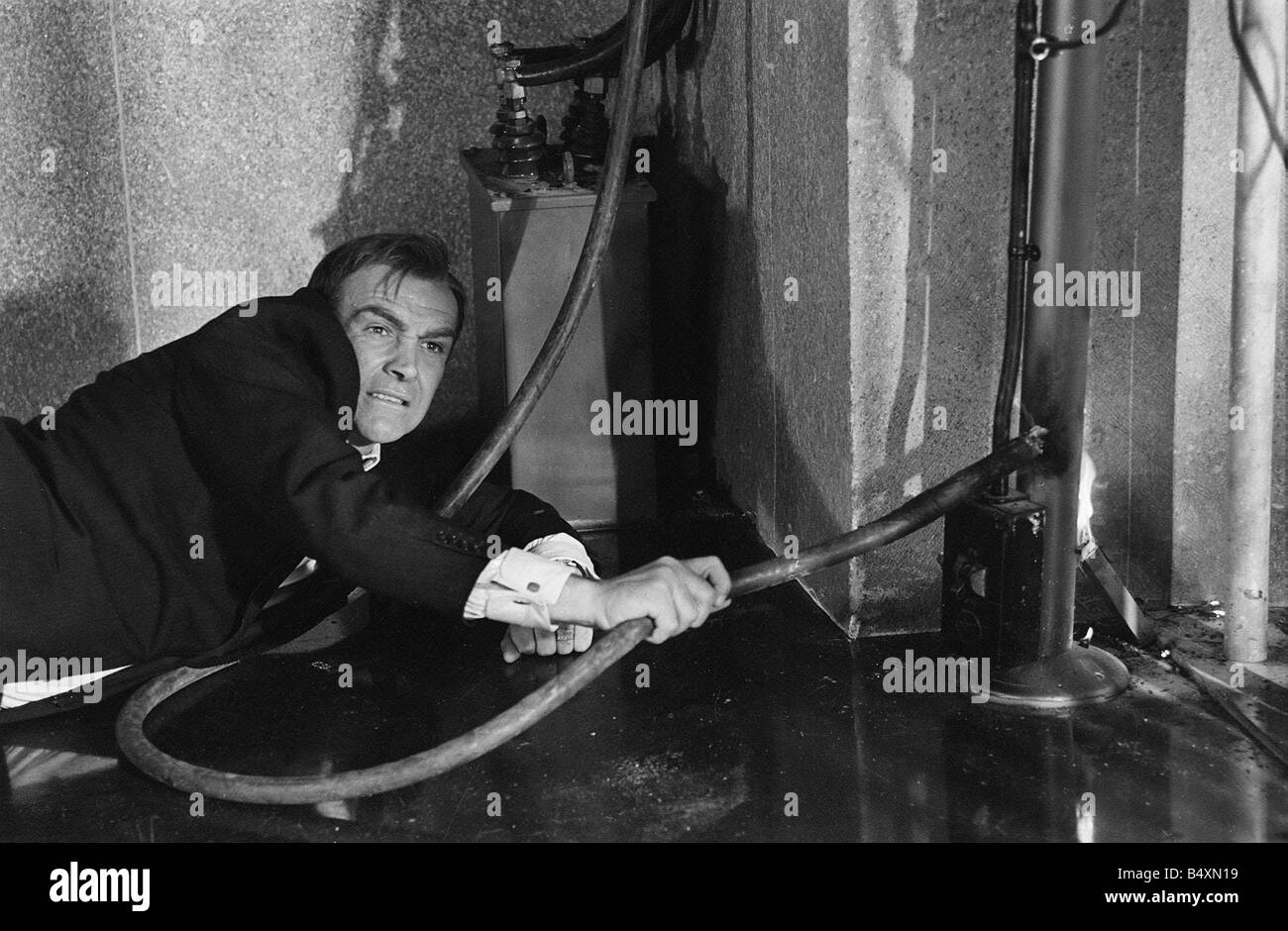 Film Goldfinger 1964 Sean Connery as James Bond 007 electrocutes Goldfinger s henchman Odd Job in the vault at Fort Knox Stock Photo
