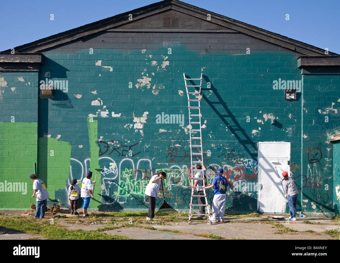Volunteers Paint Over Graffiti Stock Photo Alamy