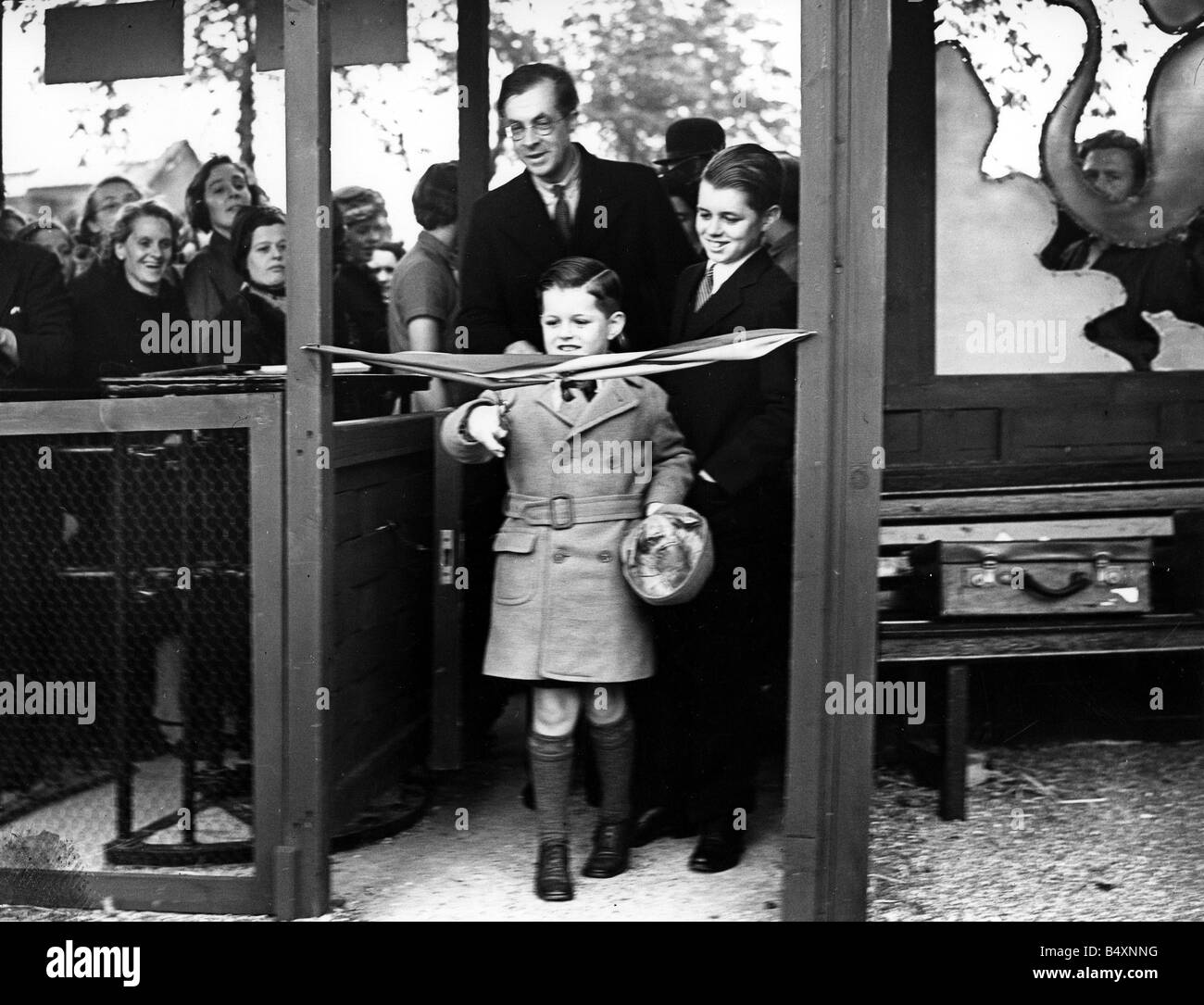 Robert Kennedy (right) watches his younger brother Edward Kennedy cut the tape to open the Children's Zoo in Regents Park, London. ;They are the two youngest sons of the American Ambassador to London, Joseph Kennedy, ;June 1938; Stock Photo