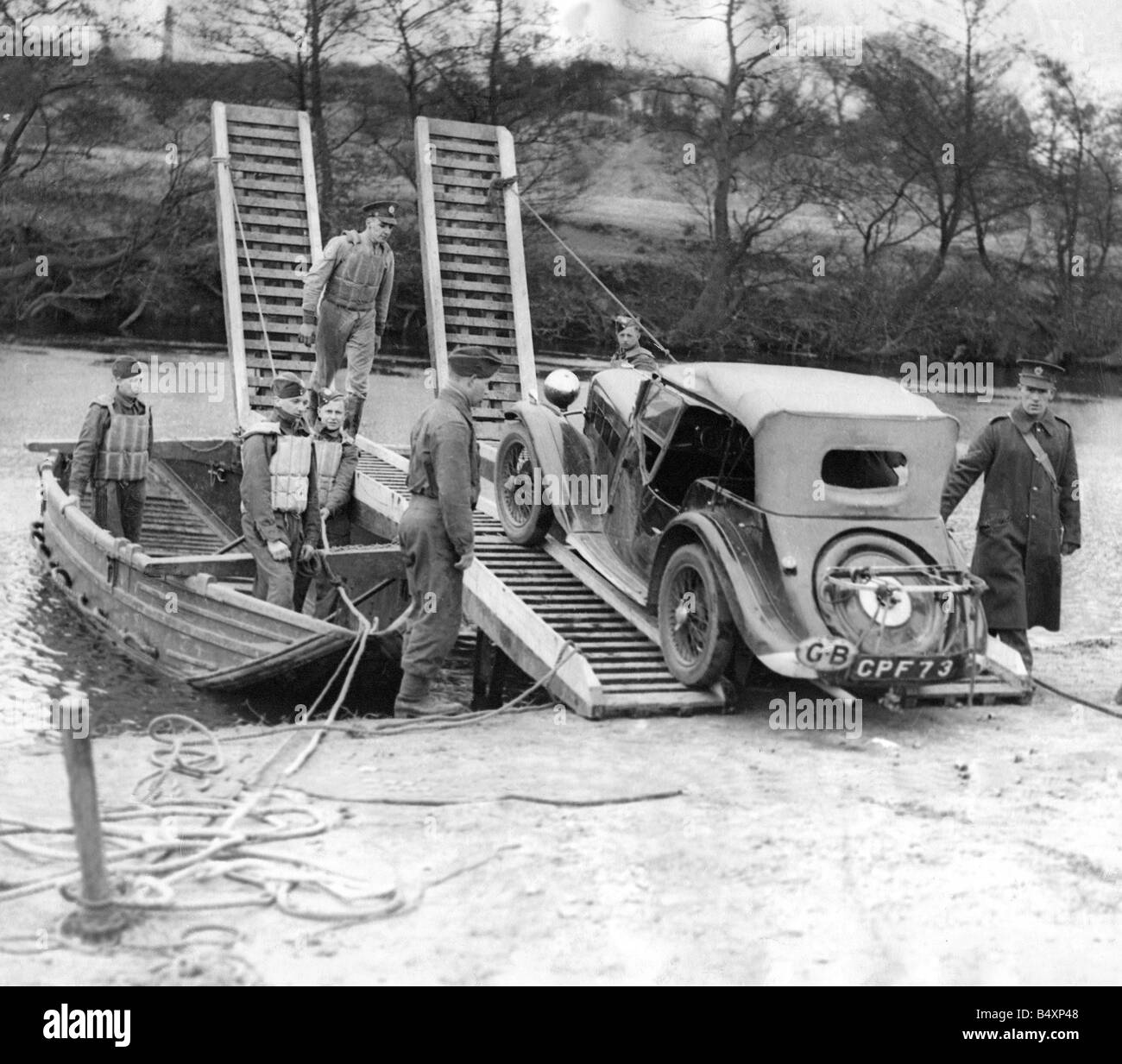The problem of transporting a car across a river is soon solved by Royal lEngineers with the use of a tracked raft These recruits are demonstrating the military engineering at the Royal lEngineers training centre somewhere in the Northern Command area Stock Photo