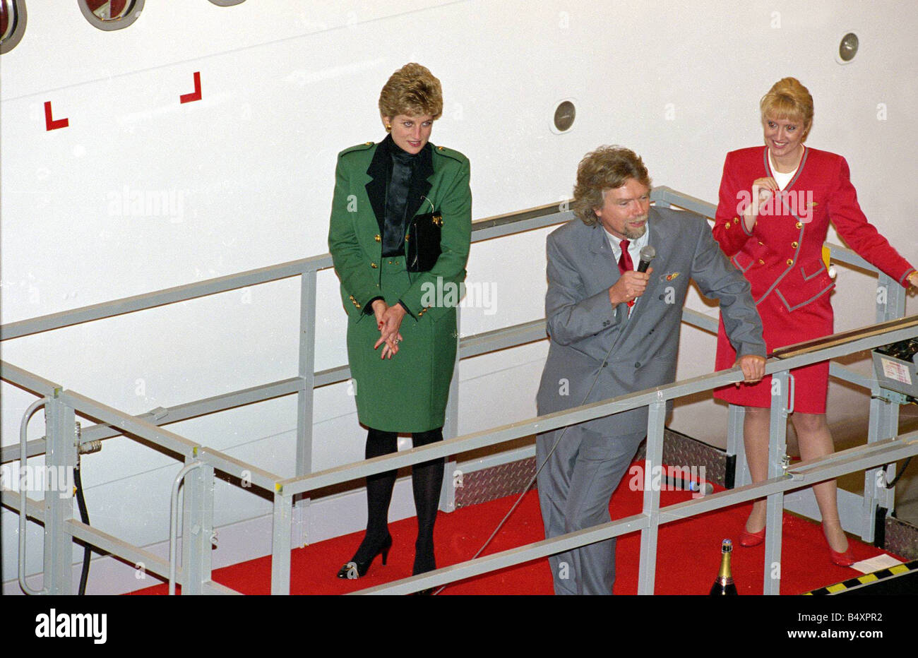 Princess Diana with Richard Branson December 1993 at Virgin Boat Launch Lady in Red green matching outfit standing on platform Stock Photo