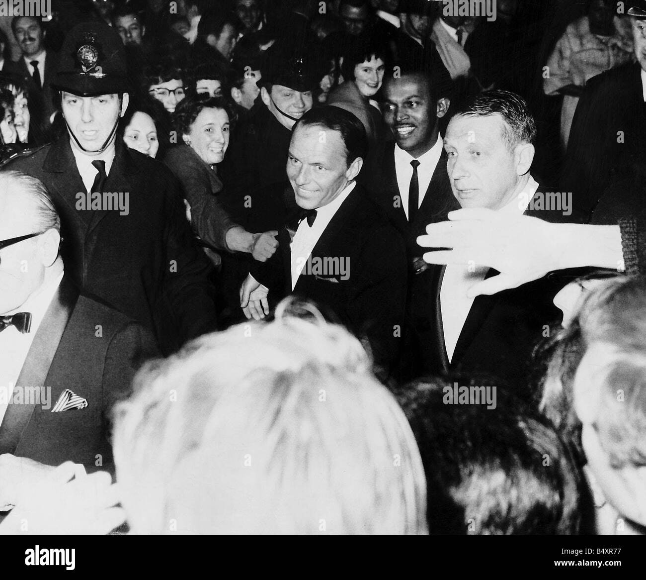 Frank Sinatra at his concert as woman fans try to grab him Stock Photo -  Alamy