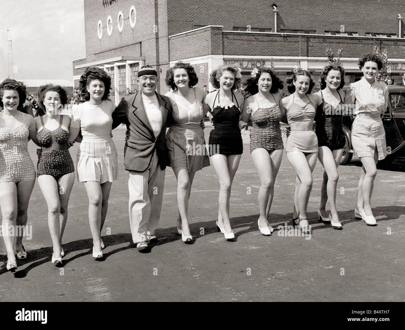 A line up of girls women wearing swimming costumes bathing suits Stock