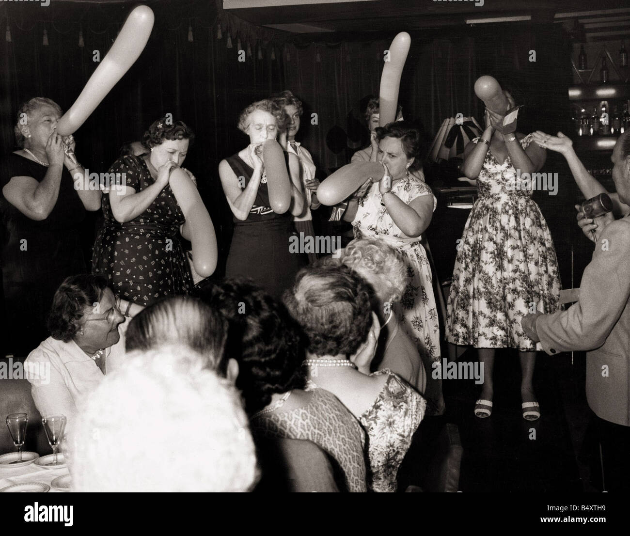 At the Plantation Night Club in Nice France British members of the coach party tour through the night life of Nice Here some took part in a ladies balloon blowing contest which was won by a British tourist Mrs Philipa Lark from Esher Women Holidaymakers June 1958 Stock Photo
