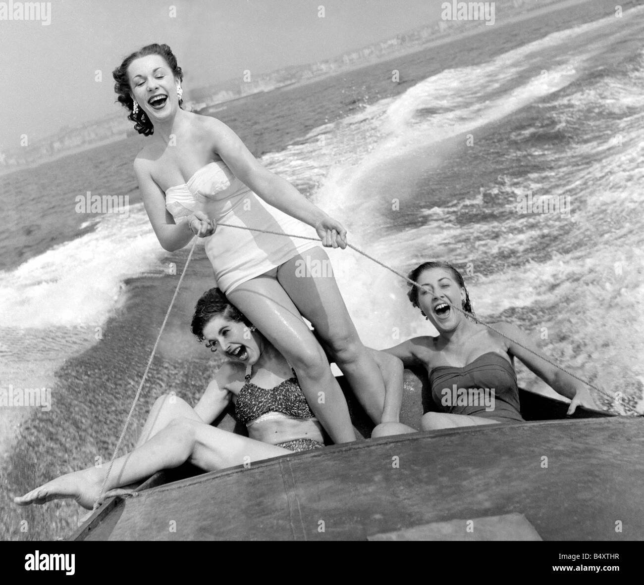 Out on the ocean waves August 1954 3 girls go for a spin on a speedboat in Brighton Shirley Orwan standing Anne Williams bikini Stock Photo