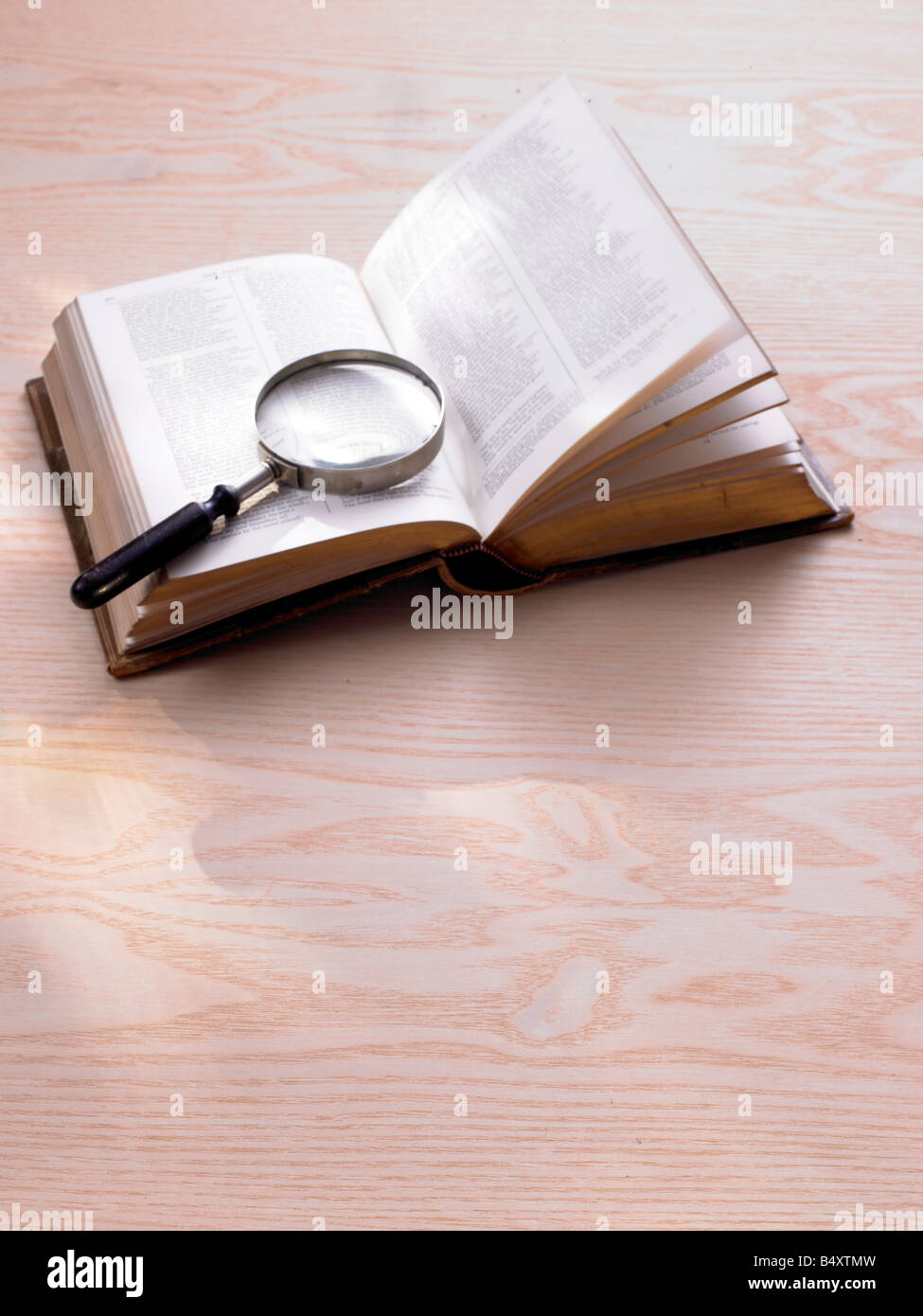 book and magnifying glass Stock Photo Alamy
