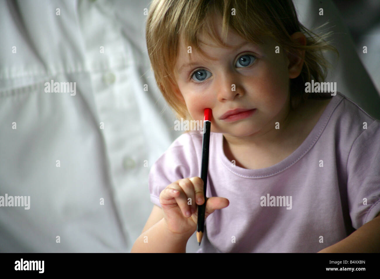 Close-up of a girl holding a pencil Stock Photo - Alamy