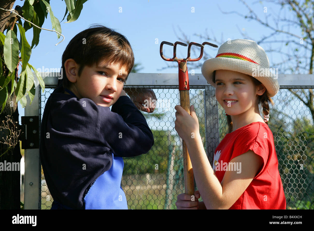 Child holding rake hi-res stock photography and images - Alamy