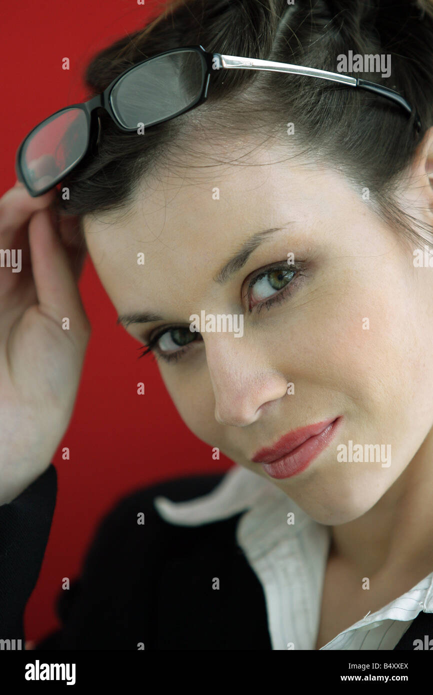 Young woman holding glasses, smiling, portrait Stock Photo Alamy