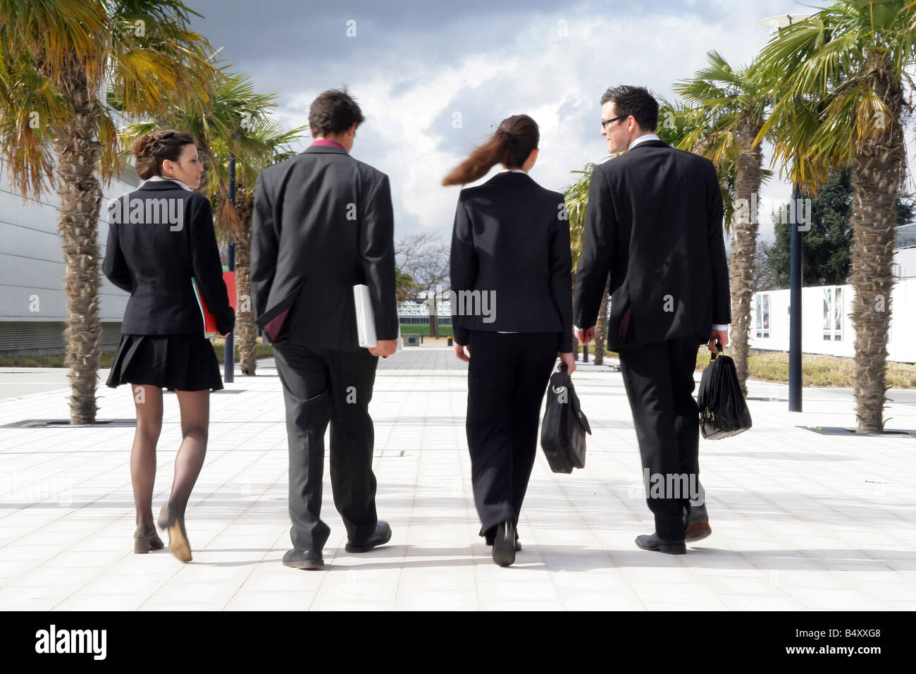 Business people walking together along sidewalk Stock Photo - Alamy