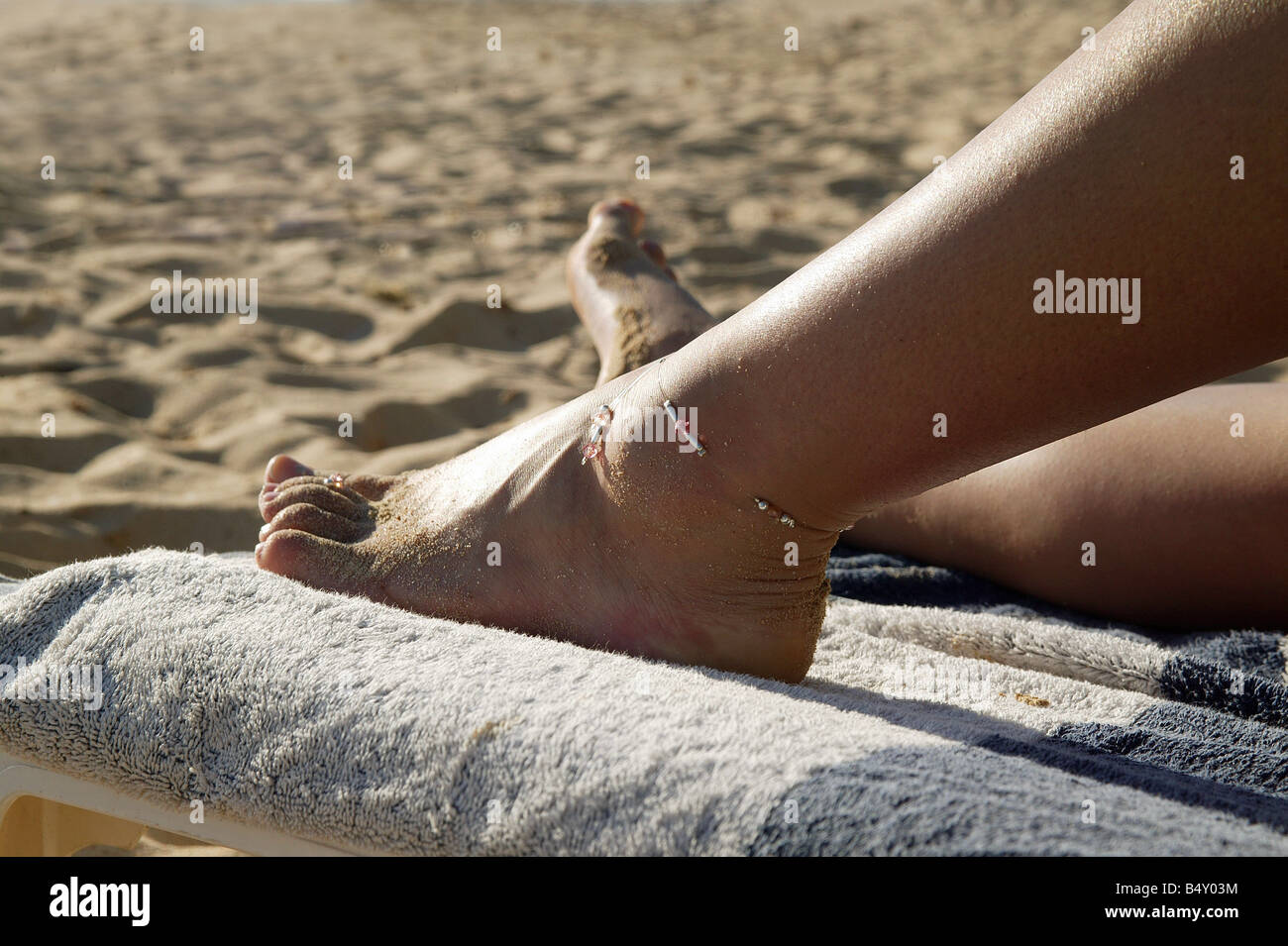 Young woman relaxing on lounge chair Stock Photo - Alamy