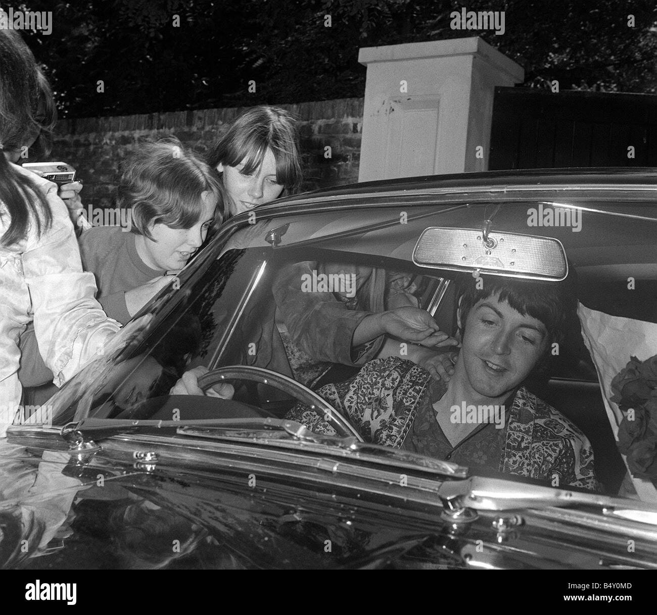 Paul McCartney of The Beatles June 1967 sitting in his car outside his ...
