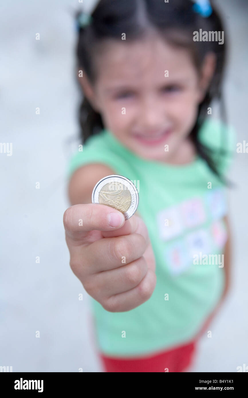 little girl with 2 euro coin Stock Photo Alamy