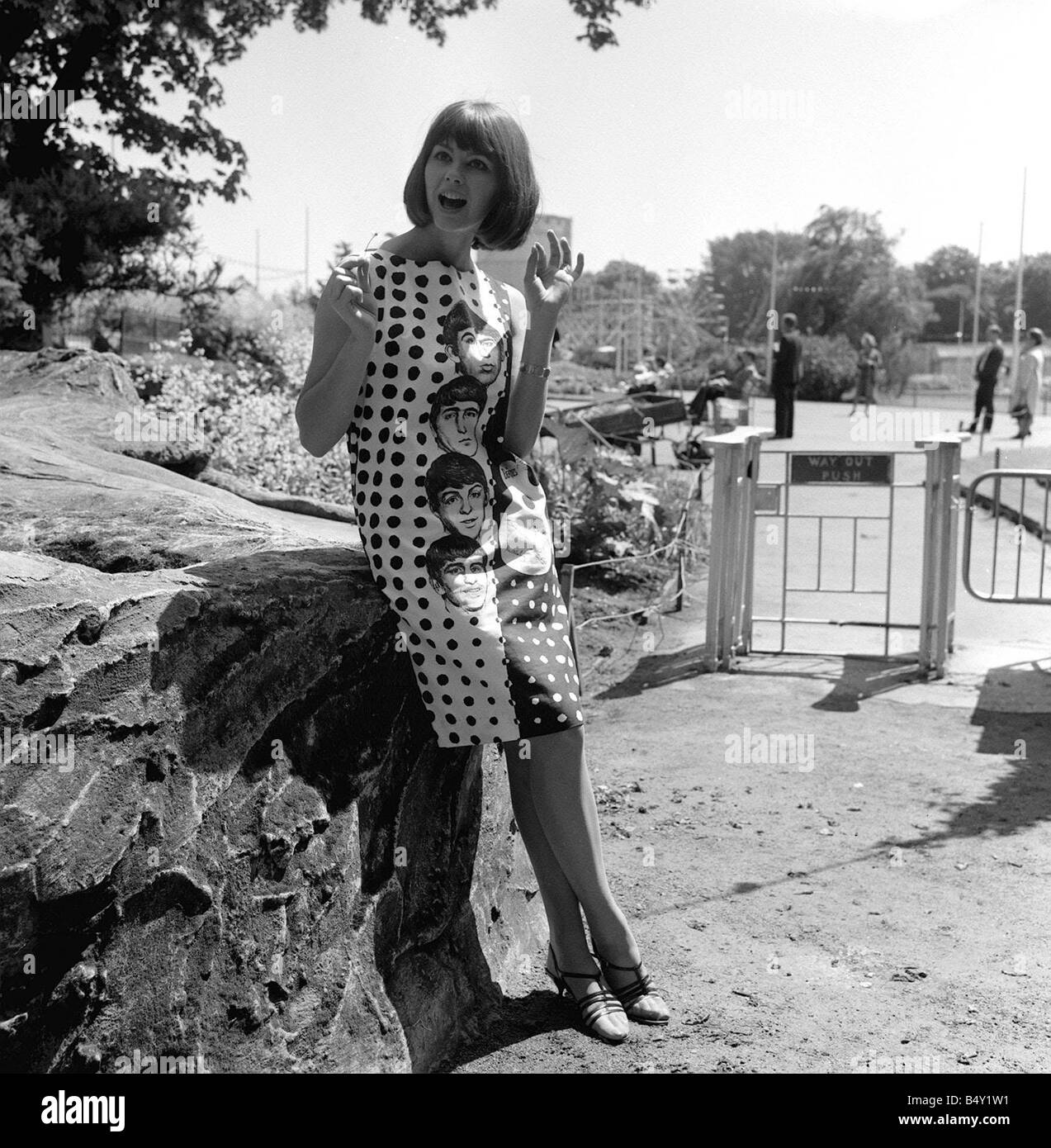 Pop Group The Beatles June 1964 John Lennon Paul McCartney Ringo Starr George Harrison Sandy Hilton modeling a Beatle dress in Battersea Park which will be on sales later this summer in C A modes Stock Photo