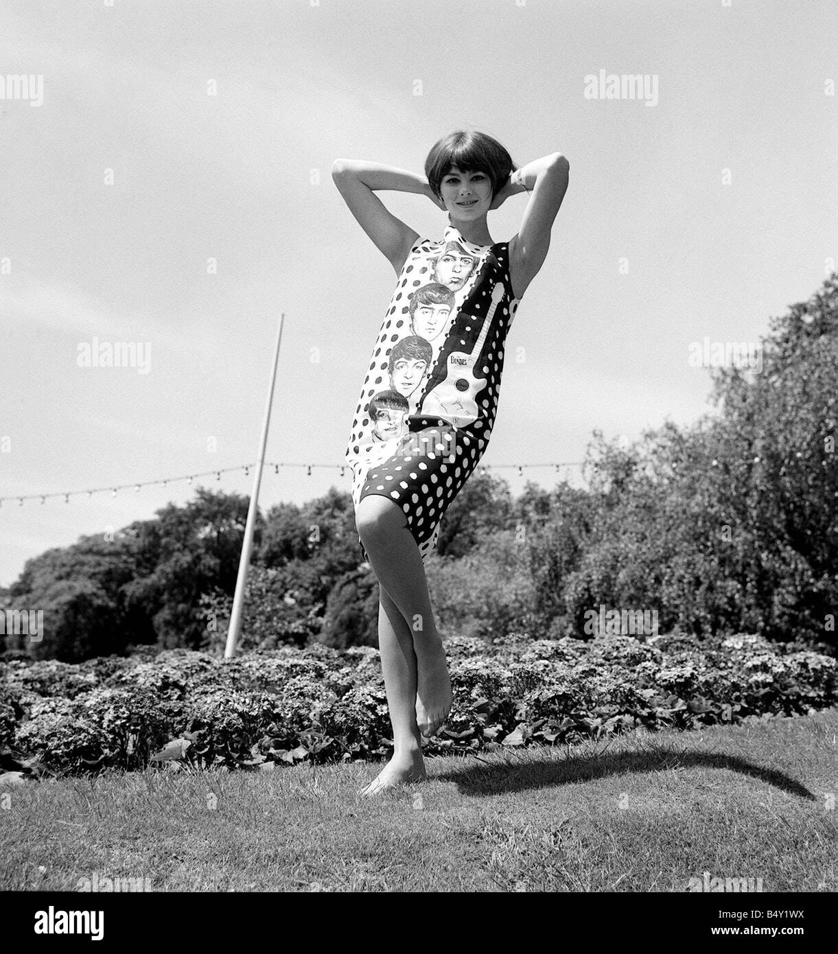 Pop Group The Beatles June 1964 John Lennon Paul McCartney Ringo Starr George Harrison Sandy Hilton modeling a Beatle dress in Battersea Park which will be on sales later this summer in C A modes Stock Photo