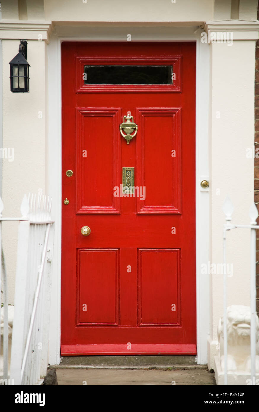 Bright red front door with brass door furniture letterbox and a