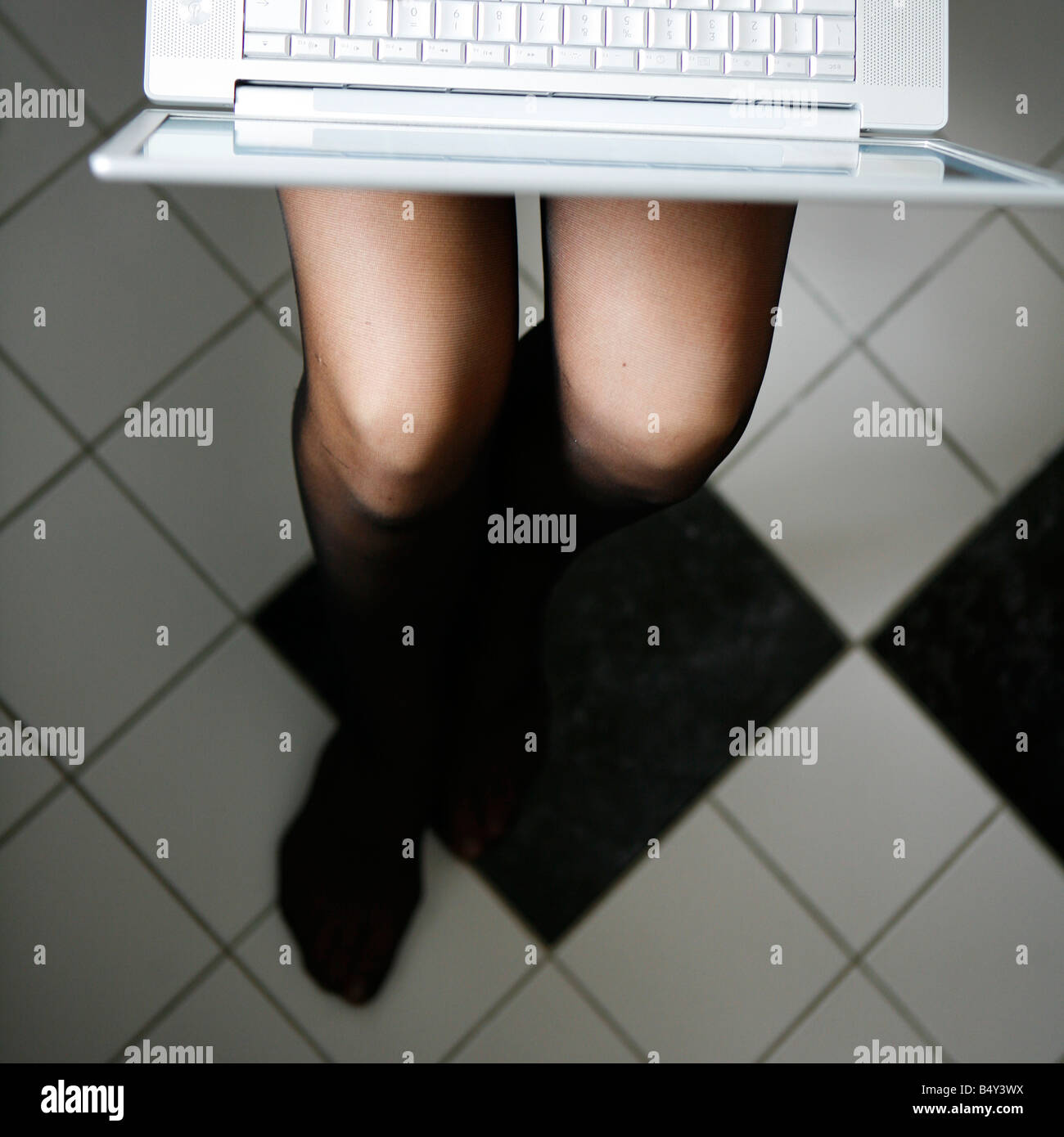 young woman in the bathroom with laptop Stock Photo Alamy