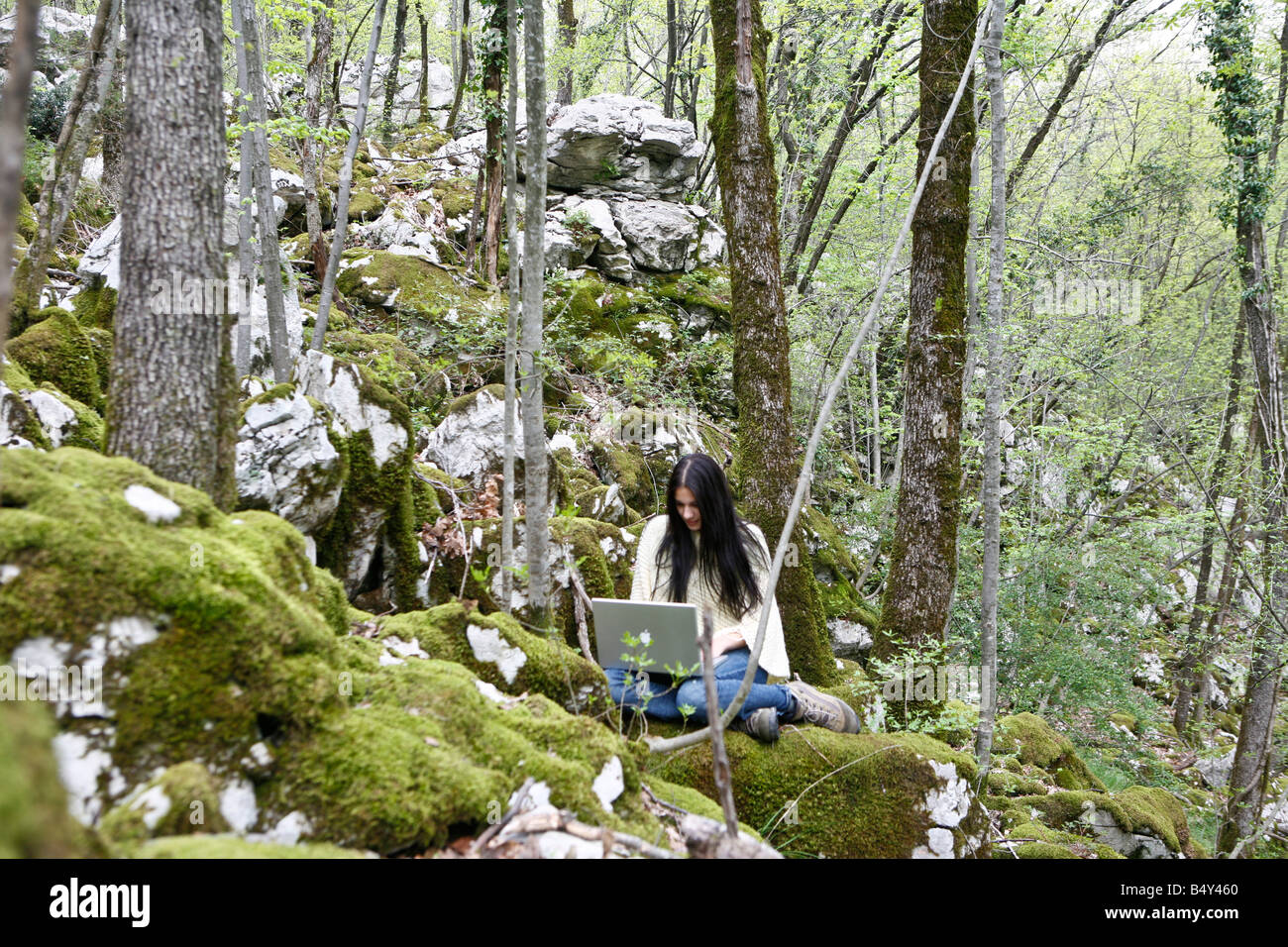 young woman with laptop in the wood Stock Photo - Alamy