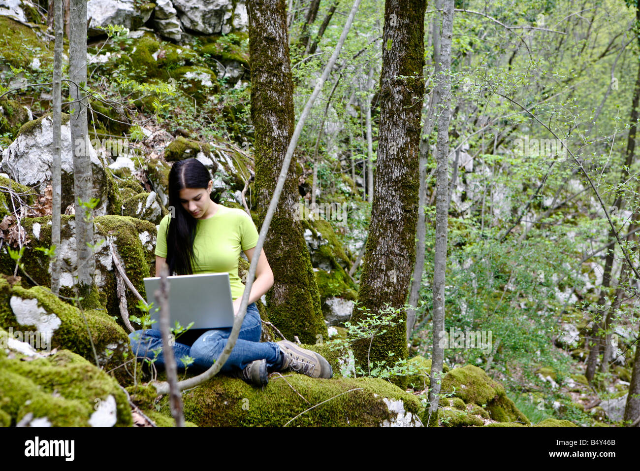 young woman with laptop in the wood Stock Photo - Alamy