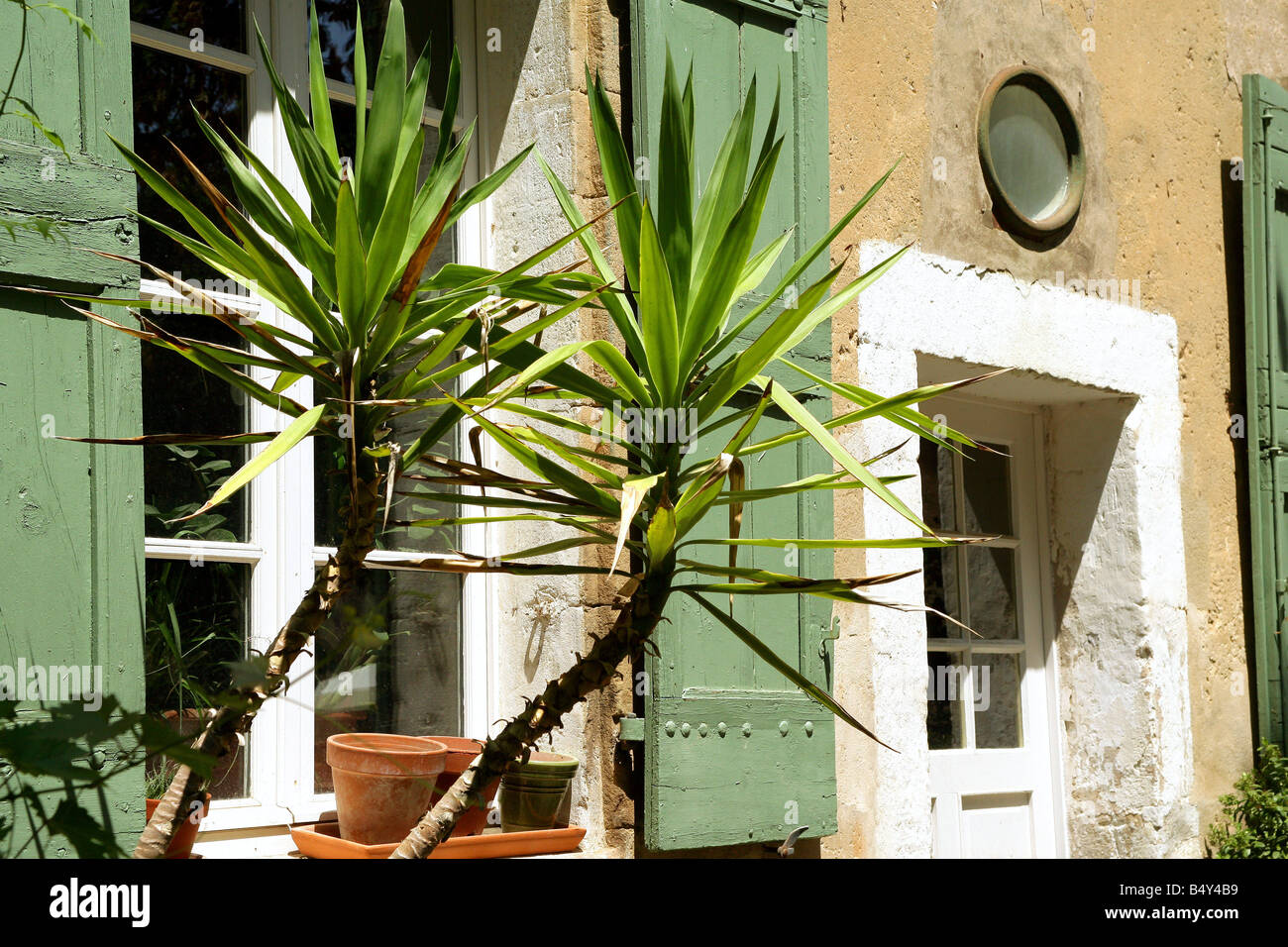 stone house facade and window with wood shutters Stock Photo - Alamy