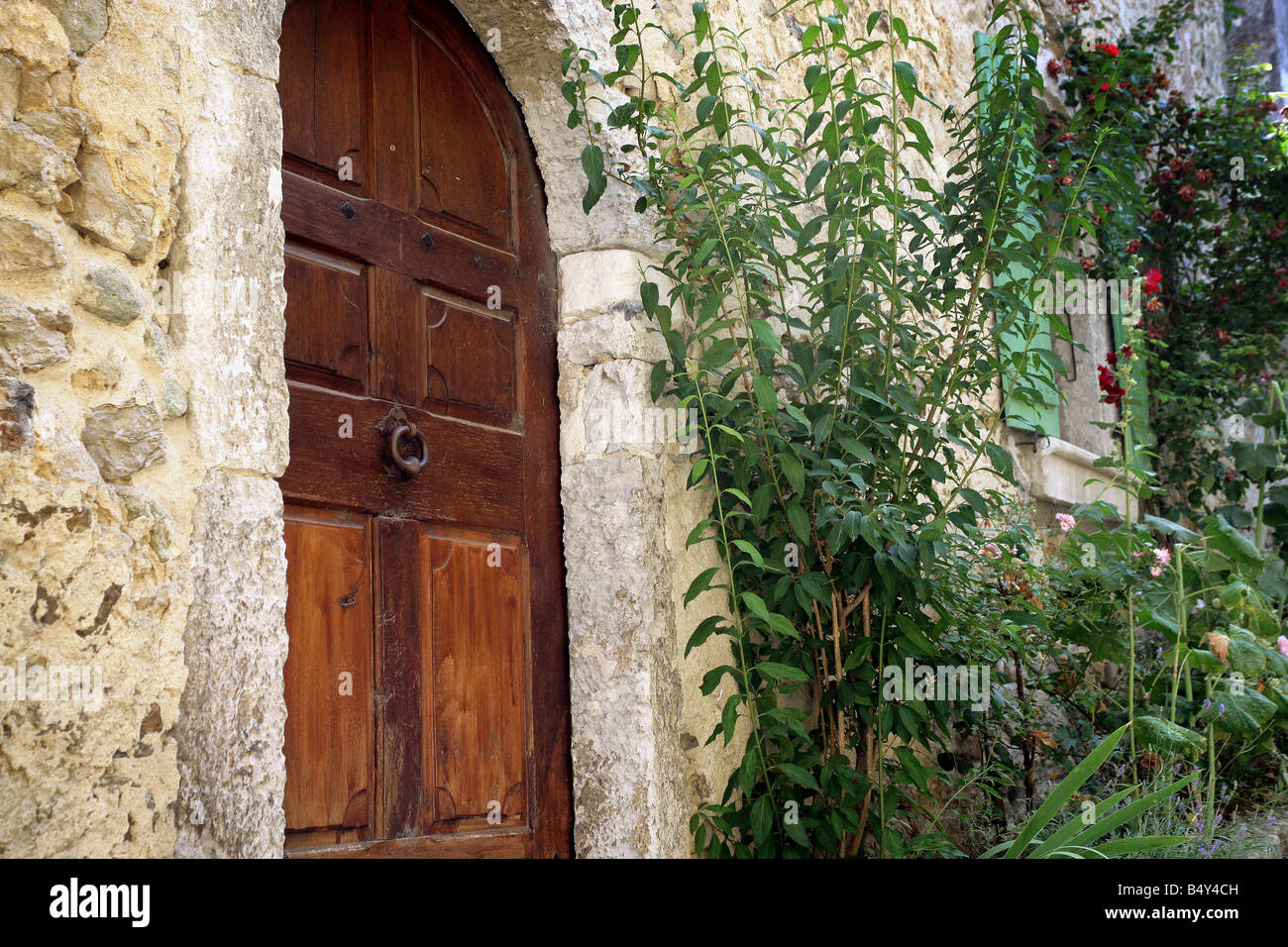stone house facade with wood entrance door Stock Photo - Alamy