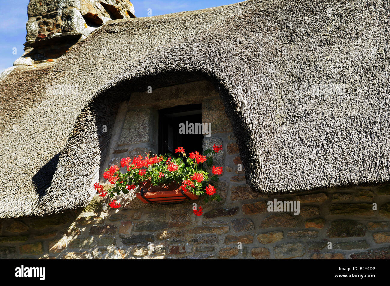 stone house facade with small window and flowers Stock Photo - Alamy