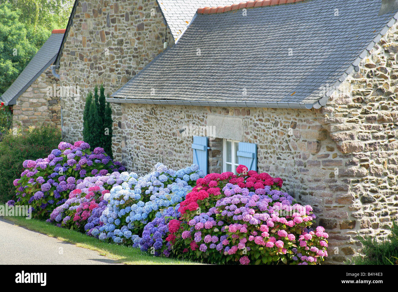 stone house facade with flowers Stock Photo - Alamy