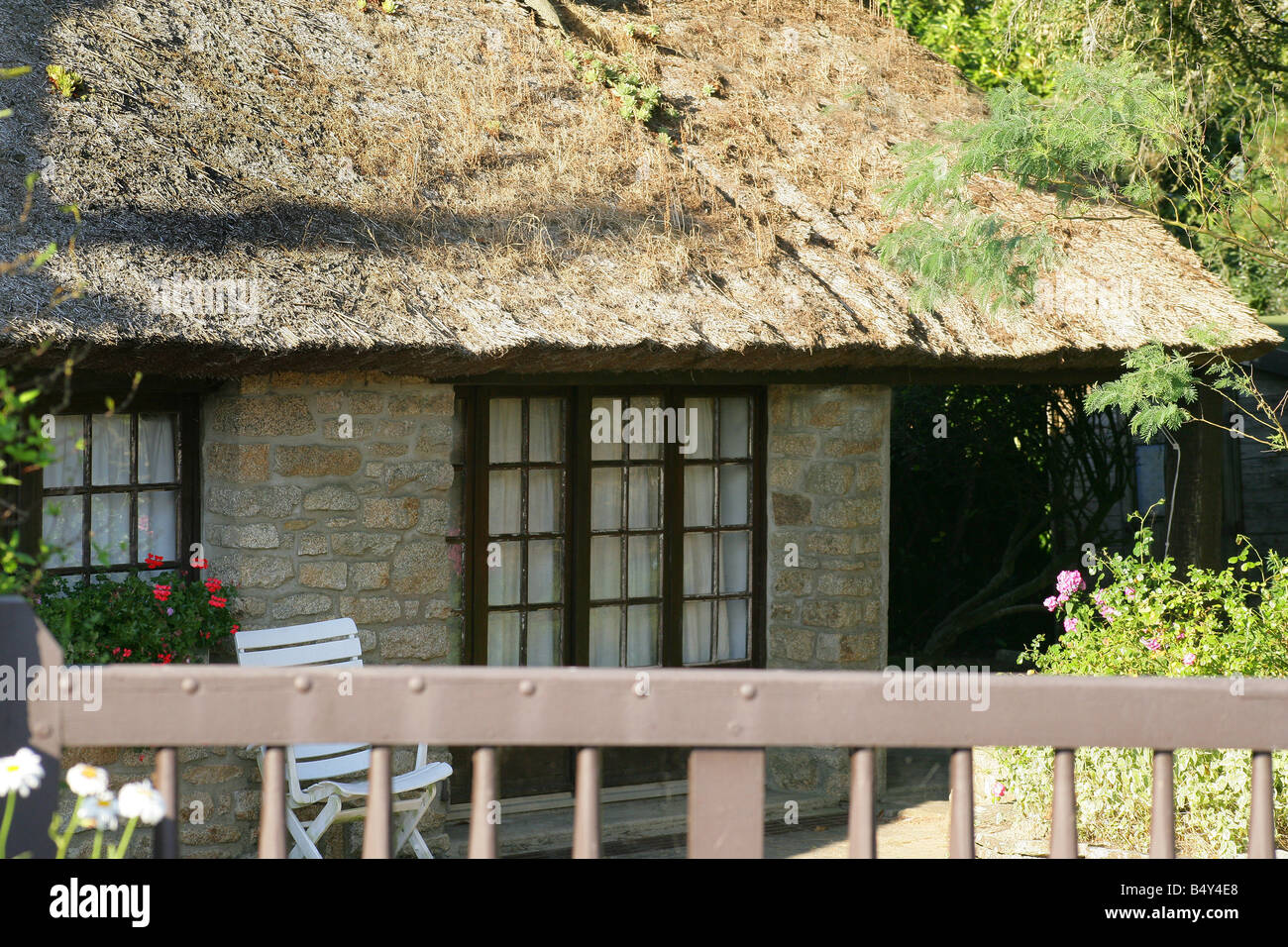 stone house facade with windows and a garden Stock Photo - Alamy